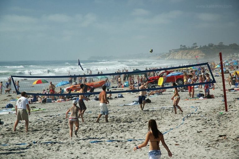 people playing beach volleyball on a sunny beach near San Diego