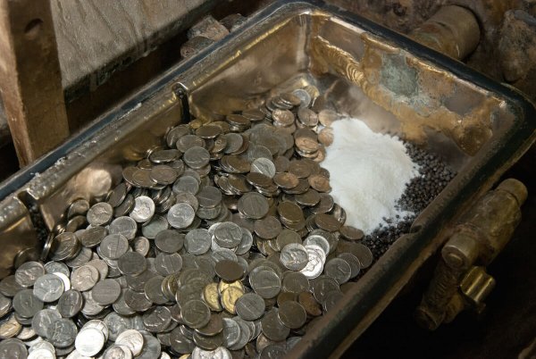 dirty coins in a historic steel drum