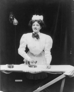House maid ironing a lace doily with GE electric iron, Photo copyrighted by General Electric Co., Public domain, via Wikimedia Commons