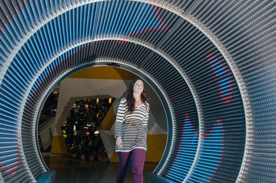 An employee of mobile gaming company Zynga walks through a colorful neon-light tunnel at Zynga headquarters in San Francisco.