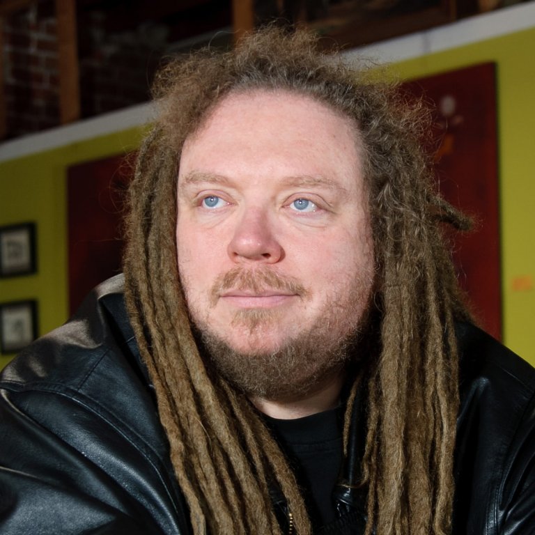 Close-up portrait of cyberspace pioneer and author Jaron Lanier at a café in Berkeley, California