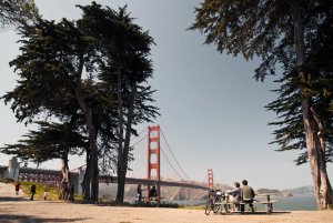 a couple relaxes at a picnic spot near the Golden Gate Bridge