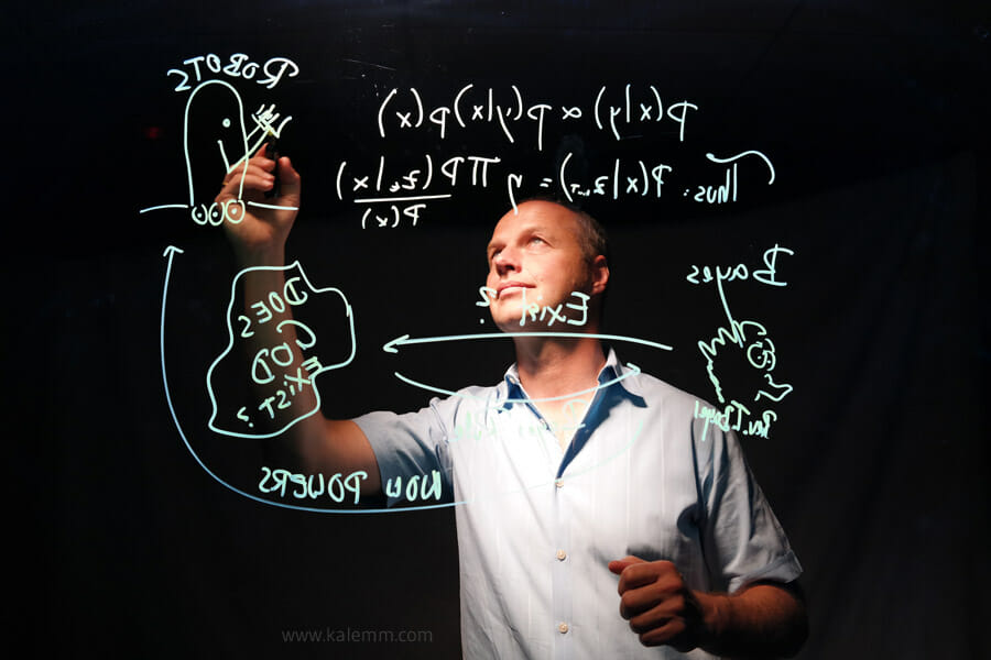 photo of Udacity founder Sebastian Thrun writing math on a glass screen