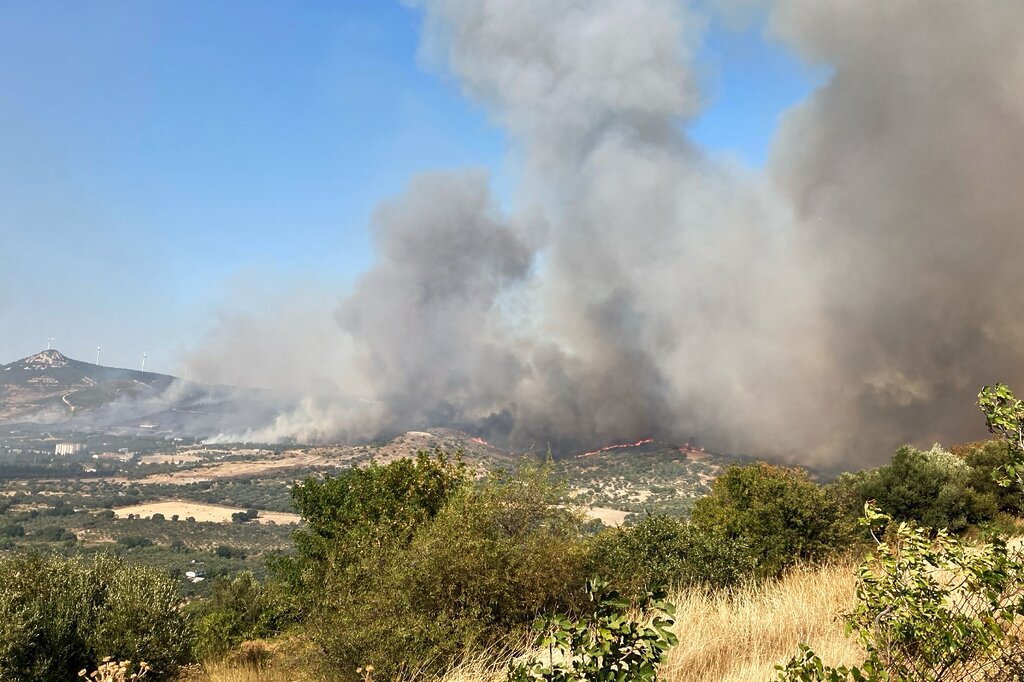 Waldbrand in der Nähe von Izmir: Über einem Berghang steigen schwarze Rauchwolken auf.