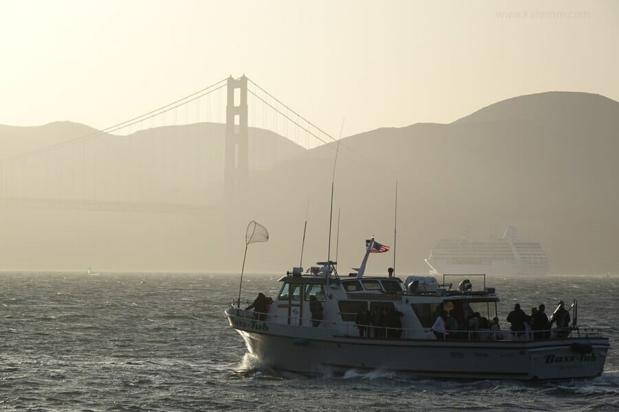 Fishing boat and cruise ship at the Golden Gate Bridge